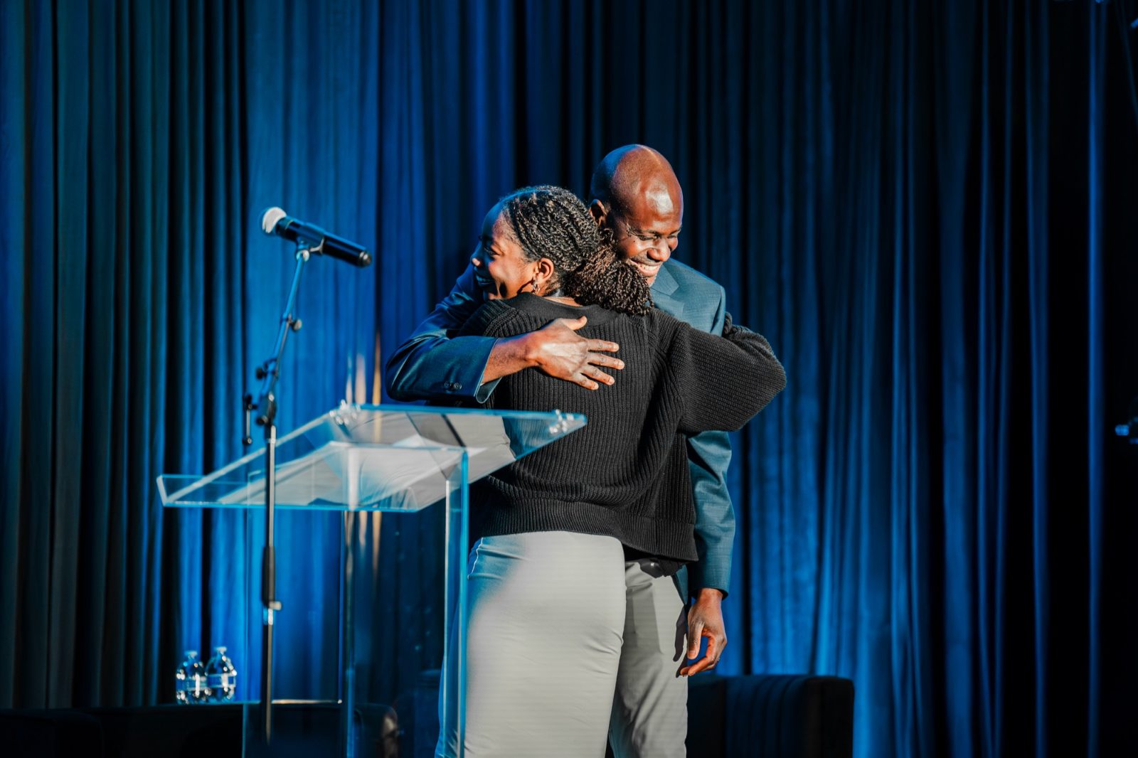 Two people embracing on stage during the MWWV Summit awards